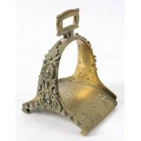 An 18th century brass stirrup: with cast foliate decoration, 18cm high.