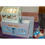 A 20th Century doll's shop 'Bridal Fayre' with green house cake shop above, together with figures,