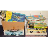 A collection various empty model kit boxes containing associated built model kits of cars,: etc.