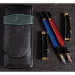 Two Pelikan M600 Souveran fountain pens: one in red and black ,
