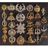 A group of various regimental cap badges: including Northamptonshire,