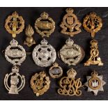 A small group of WWII cap badges: including Tank Regiment, RAC, Devonshire Regiment and others.