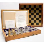 A cased Franklin Mint 'Tournament of Camelot' chess set and board: the cast pewter pieces