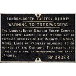 A LNER cast iron trespass penalty notice: white raised text with border, 43 x 66cm.