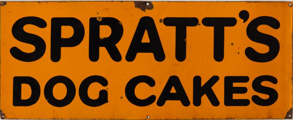 An enamel sign 'Spratt's Dog Cakes:' black text on an orange ground, 30 x 76cm.