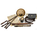 A collection of various militaria: comprising a brown leather belt with a collection of cap badges