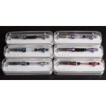 A group of six TWSBI (Taiwan) Diamond 580AL Piston filing fountain pens: in blue, purple, rose,
