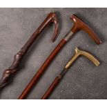 A silver mounted Plantation walking stick: (assay rubbed) together with a bras handled walking