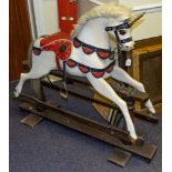 A Unicorn rocking horse:, with gilt spiral horn over painted face with glass eyes,