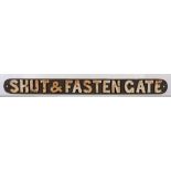 A cast iron sign 'Shut & Fasten Gate': white raised text, 7.5 x 80.
