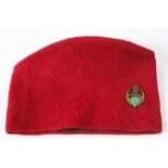 A WWII period 6th Regiment De Tiraillieurs Algerians red cloth fez with enamel regimental badge:.