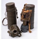 A WWII period German gas mask in container: the base stamped 'S.A.F.