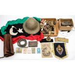 A collection of various militaria: including cap badges and shoulder badges,