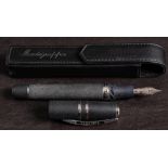 A Visconti 'Homo Sapiens' basaltic lava fountain pen with silver nib and mounts: in an associated