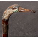 An early 20th century carved bird's head walking cane with silver ferrule by John Howell& Co, Ltd,