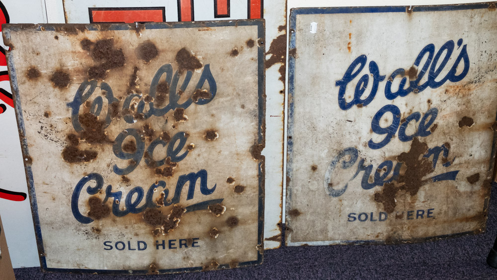 Two enamel signs 'Wall's Ice Cream Sold Here': blue text on white ground with blue border 60 x 52cm