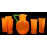 A glass lemonade set: comprising a bright orange jug with applied apple green handle and five