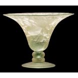 An art glass vase: the pale green body of flaring form set on a short knopped stem and domed foot,