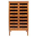 A mid 20th Century beech haberdashery cabinet:, of two flights of eight glazed drawers,