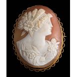 An oval shell cameo portrait brooch: depicting the goddess of Spring within a gold frame,