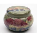 A William Moorcroft circular tobacco jar and screw cover: tubelined and decorated in the
