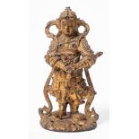 A Chinese gilt bronze and jewelled warrior figure: in traditional costume,