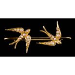 A seed pearl mounted swallow motif bar brooch: approximately 41mm long overall, un-marked.