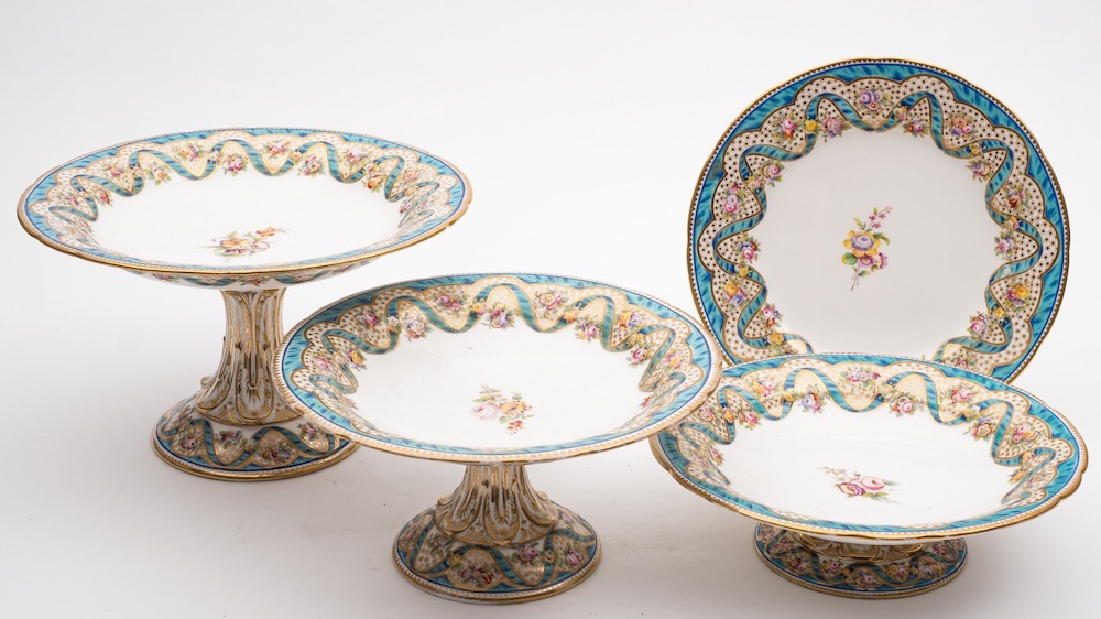 A 19th century English porcelain part dessert service: painted with a central floral spray,