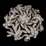 An 18ct white gold and diamond mounted circular brooch: set with round brilliant and single-cut