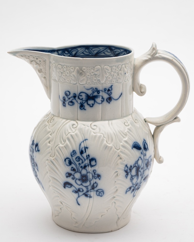 A Badderley Littler cabbage leaf jug: with scroll handle, the rim moulded with fruiting vine,