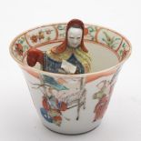 A Chinese famille rose figural 'trick' cup: the interior with a figure of Guanyin wearing flowing