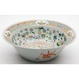 A Chinese famille rose basin: painted to the centre with a peacock amongst prunus and peony,
