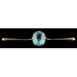 An aquamarine single-stone bar brooch: the cushion-shaped aquamarine approximately 13.5mm long x 11.