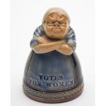 A Royal Doulton stoneware 'Votes For Women' Suffragette figural inkwell: the virago woman with arms