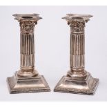 A pair of Victorian silver Corinthian column dressing table candlesticks, maker Martin, Hall & Co,