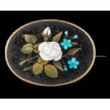 A pietra dura oval brooch: depicting a floral bouquet approximately 56mm long overall,