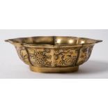 A Chinese polished bronze quatrefoil bowl: of lotus form, the exterior engraved with a crab, birds,