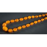 A graduated amber bead single-string necklace: composed of sixty oblong beads,