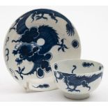 A Lowestoft blue and white dragon pattern teabowl and saucer: each piece painted in rich underglaze