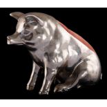 A large novelty metal pin cushion: modelled in the form of a seated pig, 11cm high.