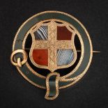 A Victorian yellow metal and agate mounted brooch: of circular buckle form,