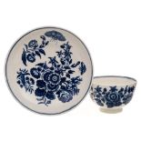 A First Period Worcester teabowl and saucer: printed in the 'Three Flowers' pattern [I.I.