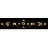 An Edwardian peridot and seed pearl bar brooch: approximately 63mm long, 4gms gross weight,