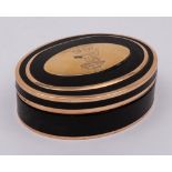 A gold mounted tortoiseshell oval box: the hinged lid with crest of stag beneath a tree,