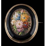 An oval mosaic brooch of floral design: approximately 46mm long, 18gms gross weight,