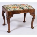 An early 18th Century walnut stool:, with a rectangular upholstered slip in seat on cabriole legs,