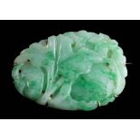 A carved jade panel brooch: approximately 40mm long x 29mm wide,