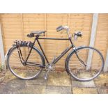 A 1920s Rudge bicycle: black frame with chrome plated handlebars, bar brakes,