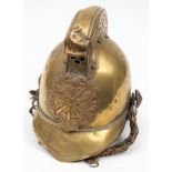 An early 20th century Merryweather pattern fireman's brass helmet: the comb with repouse dragon