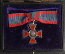 A George V Royal Red Cross, 2nd Class: silver and enamel on lady's bow riband, in Garrard,